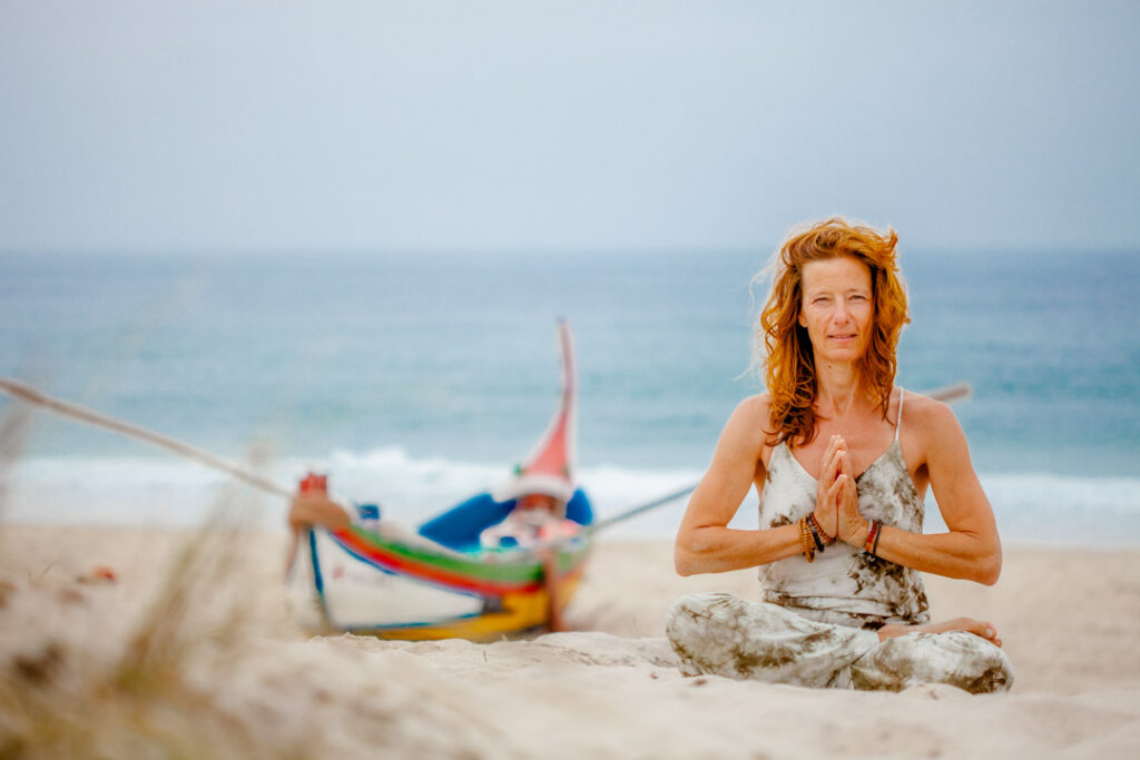 woman in beach wear sitting in gratitude 